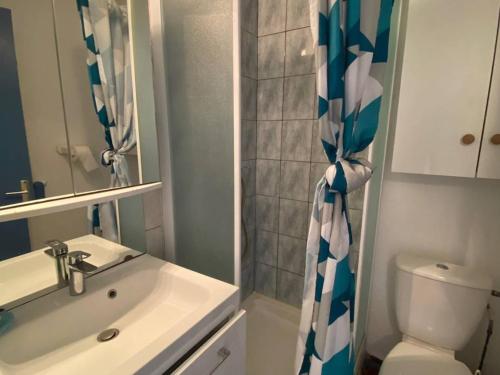 une salle de bain avec un lavabo et un rideau de douche dans l'établissement Studio cabine 4 pers avec piscine, parking et animaux admis - Port Barcarès - FR-1-81-447, au Barcarès