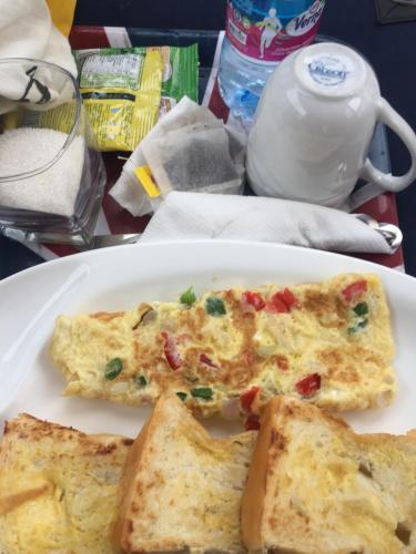 a plate of omelet and bread on a table at Marrets International Hotel - "Express" in Cape Coast