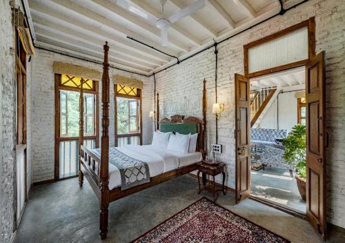 a bedroom with a bed and a large mirror at SaffronStays Amolee, Alibaug in Alibaug