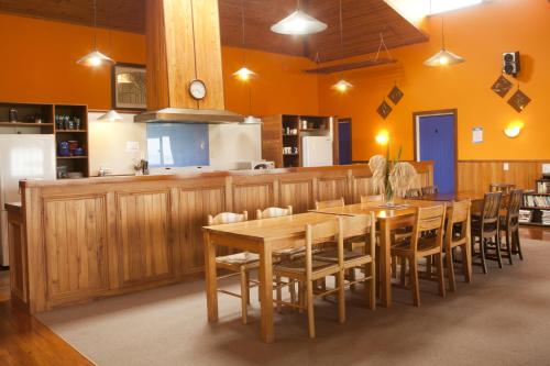 a dining room with a wooden table and chairs at Old Bones Lodge in Oamaru