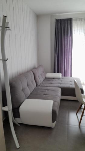 a living room with a couch and a chair at I Faraglioni Comfort Rooms in Terrasini