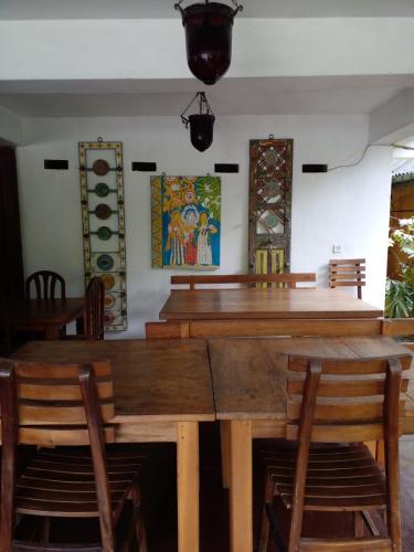 a dining room with a wooden table and chairs at Traditional Kandyan House in Kandy