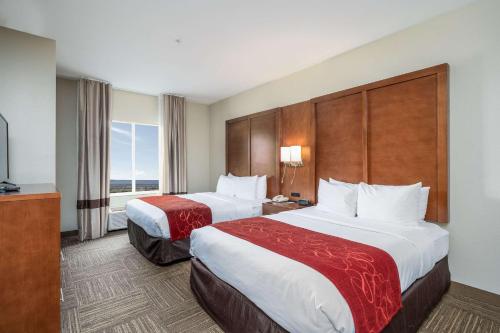 a hotel room with two beds and a large window at Comfort Suites University in Abilene