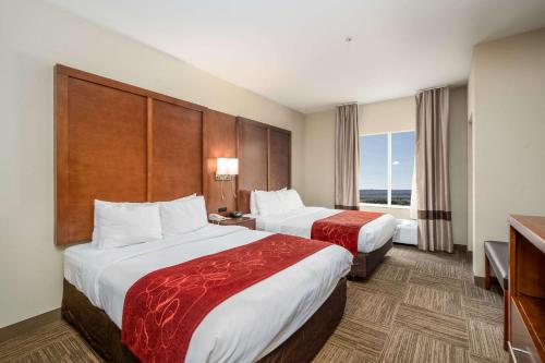 a hotel room with two beds and a window at Comfort Suites University in Abilene