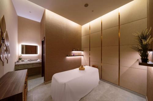 a bathroom with a white table and a sink at Radisson Hotel Riyadh Airport in Riyadh