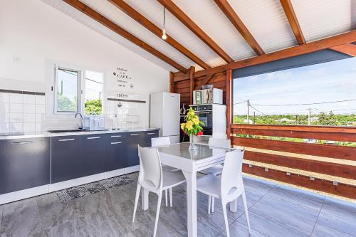 a kitchen with a table and chairs in a kitchen at Kozy Kaz in Le Gosier