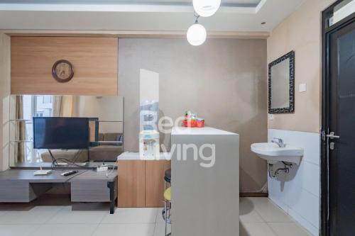 a living room with a sink and a desk with a computer at RedLiving Apartemen Gateway Pasteur - TN Hospitality 3 Tower Jade B in Bandung