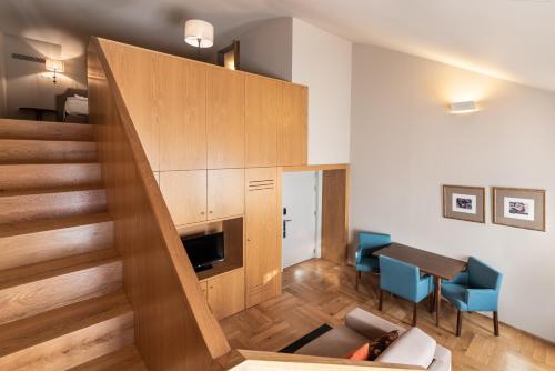 a living room with a staircase leading up to a loft at Eurostars Santa Luzia in Guimarães