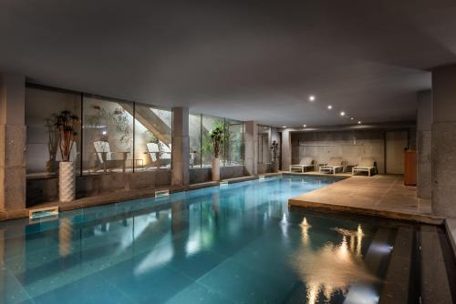 a large swimming pool in a building at Eurostars Santa Luzia in Guimarães