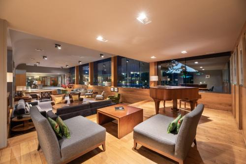 a living room filled with furniture and a piano at Eurostars Santa Luzia in Guimarães