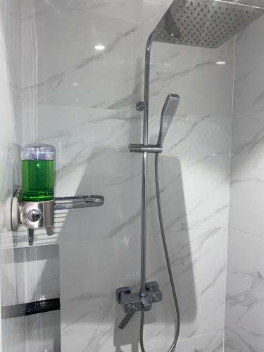 a shower with a green liquid in a glass door at Walking Street Condo Beautiful 1 king bedroom in Angeles