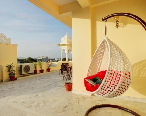 a hammock hanging from a wall on a balcony at Vasant Vilas in Udaipur
