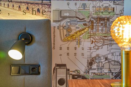 a room with a map on the wall and a lamp at PLAZA INN Ulm in Ulm