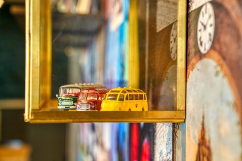a shelf with toy cars and a bus in front of a mirror at PLAZA INN Ulm in Ulm
