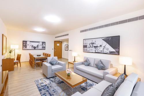 a living room with a couch and a table at Golden Sands Suites in Dubai