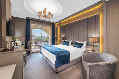 a bedroom with a bed and a chair in a room at Savoy Hotel Spa & Casino in Kyrenia