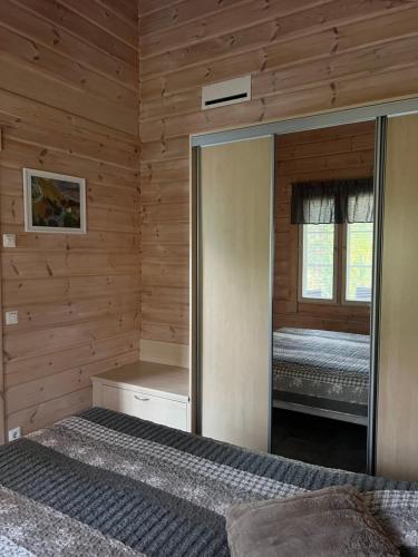 a bedroom with a mirror and a bed in it at Holiday Home Amero purnu 4 in Kolinkylä