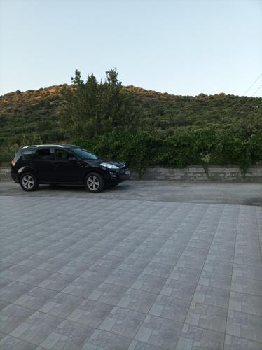 a black car parked in a parking lot at Villa Fraoulitsa in Skoutarion