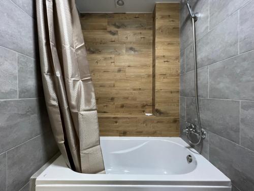 a bathroom with a shower and a white tub at Iris Hotels Resort in Vorzel