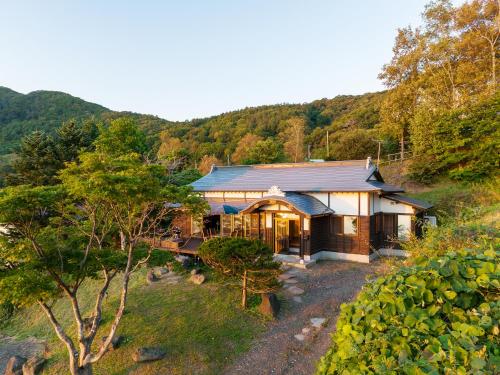 an aerial view of a house in the mountains at Toya cliff House in Lake Toya