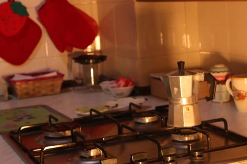 a kitchen stove with a coffee maker on top of it at casa medioevo in Viterbo