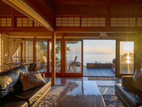 a living room with a view of the ocean at Toya cliff House in Lake Toya