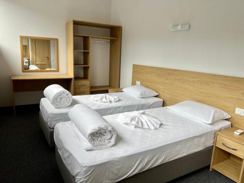 a hotel room with three beds and a mirror at Iris Hotels Resort in Vorzel