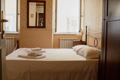1 dormitorio con 1 cama con toallas en Hotel capitelli, en Trieste