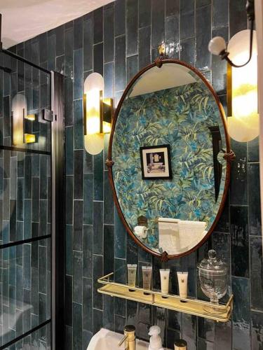 a bathroom with a mirror and a sink at Charming stone Bothy at Loch Lomond in Luss