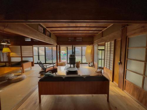 a living room with a couch and a table at 犬と泊まれる平屋Dog friendly house 黄昏 in Misaki