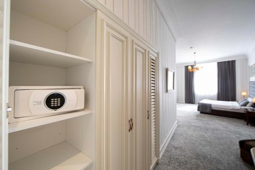 a room with a microwave sitting on a shelf at Sapphire City Hotel in Baku