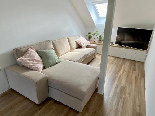a living room with a couch and a flat screen tv at Sunny Oak Estate in Mengeš