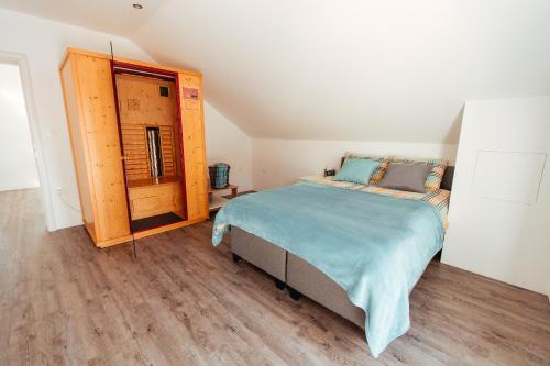 a bedroom with a bed and a wooden floor at Sunny Oak Estate in Mengeš