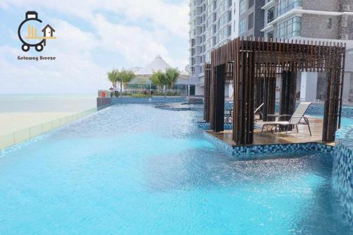 a swimming pool in the middle of a building at 1 min to Seaview & Sunrise Heart of Kuantan in Kuantan