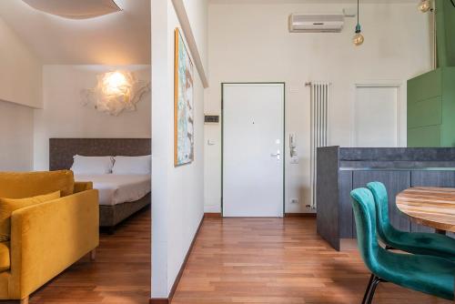 a room with a bed and a table and chairs at easyhomes Duomo View in Milan