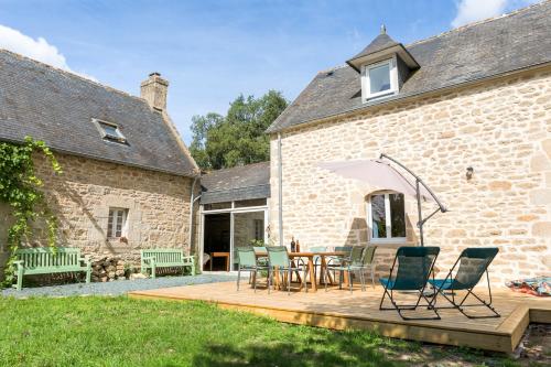 a patio with chairs and a table in front of a building at Degemer mat dans cette maison familiale ! in Loctudy