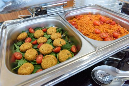a tray of food with meatballs and vegetables and rice at Primavera Jastrzębia Góra in Jastrzębia Góra