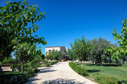 a path in a park with trees and a building at Villa Luni in  Episkopi (Chania)