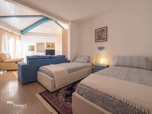 - une chambre avec deux lits et un canapé dans l'établissement Villa Octogon, à Loèche-les-Bains