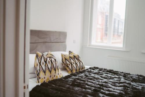 a bedroom with a bed with pillows and a window at Apartment 3 1 bedroom, sleeps x 4 in York