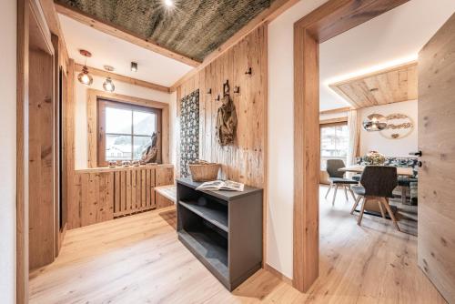 a home office with wooden walls and a wooden floor at Ferienwohnungen Fichtenheim in Mayrhofen