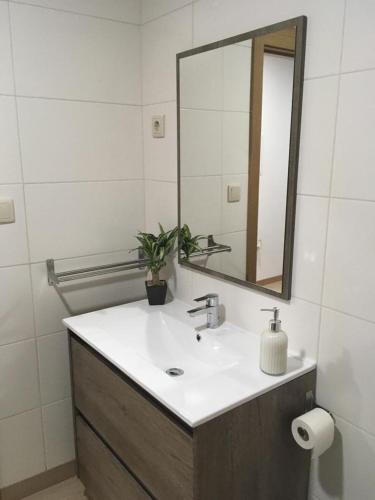 a bathroom with a sink and a mirror at Casa do Castelo II in Bragança