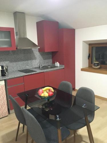 a kitchen with a table with a bowl of fruit on it at Casa do Castelo II in Bragança