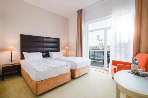 Postel nebo postele na pokoji v ubytování Resort Mark Brandenburg & Fontane Therme