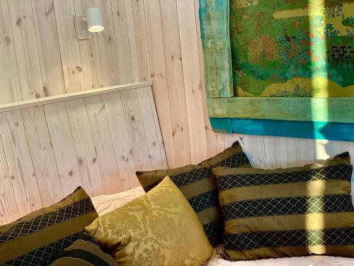 a group of pillows on a bed in a room at Bohemian Eco lodge át lake Balaton in Kisapáti