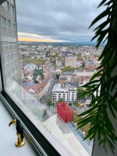 a view of a city from the window of a building at Grand appartement 2 chambres 5 pers max, vue panoramique avec parking in Mulhouse