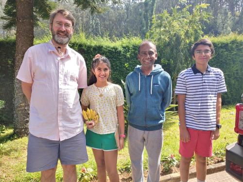 a group of three people posing for a picture at Narmada Holiday Home in Ooty