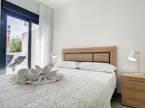 a bedroom with a bed with a bowl on it at Elisa Beach Apartment - 8209 in Santiago de la Ribera