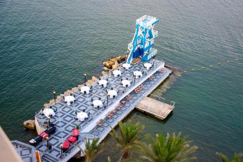 an aerial view of a pier with umbrellas on the water at Helnan Royal Palestine Hotel - Montazah Gardens in Alexandria