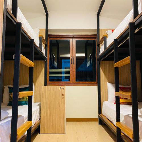 a bunk room with four bunk beds in it at Chada Mantra Hotel in Chiang Mai